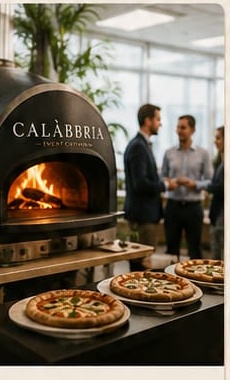 Wood-fired oven set up in an office space, colleagues chatting nearby